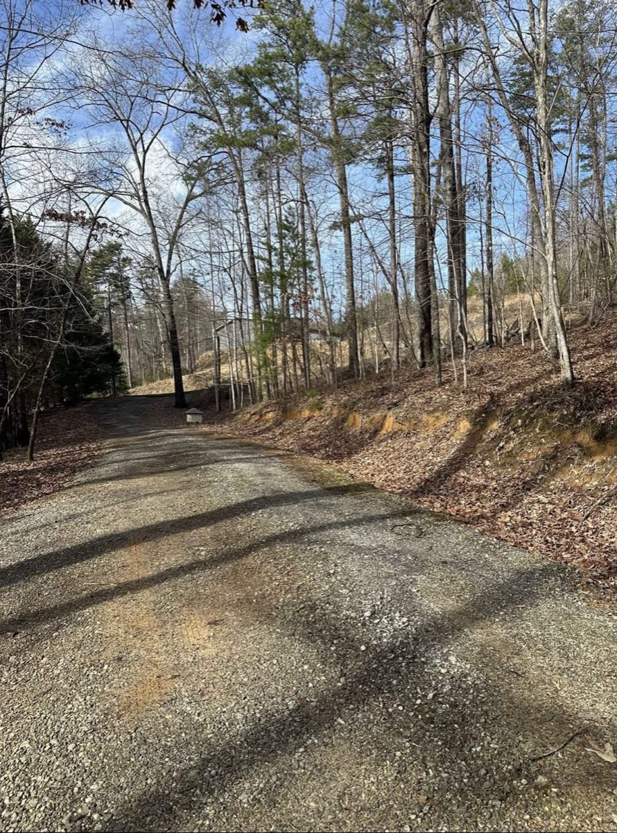 New gravel driveway through wooded property in Pickens, SC