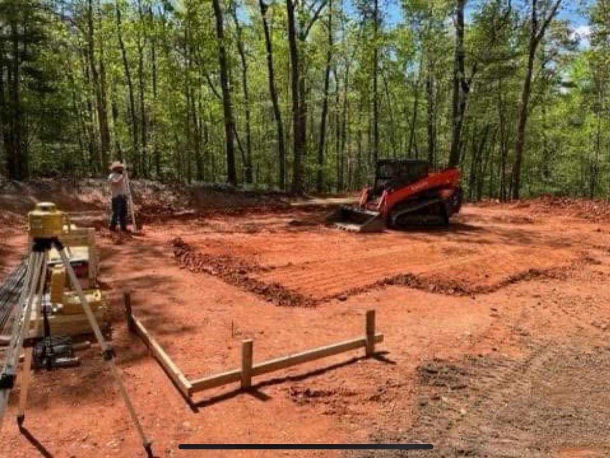 Tracked skid steer grading a house pad in Pickens, SC