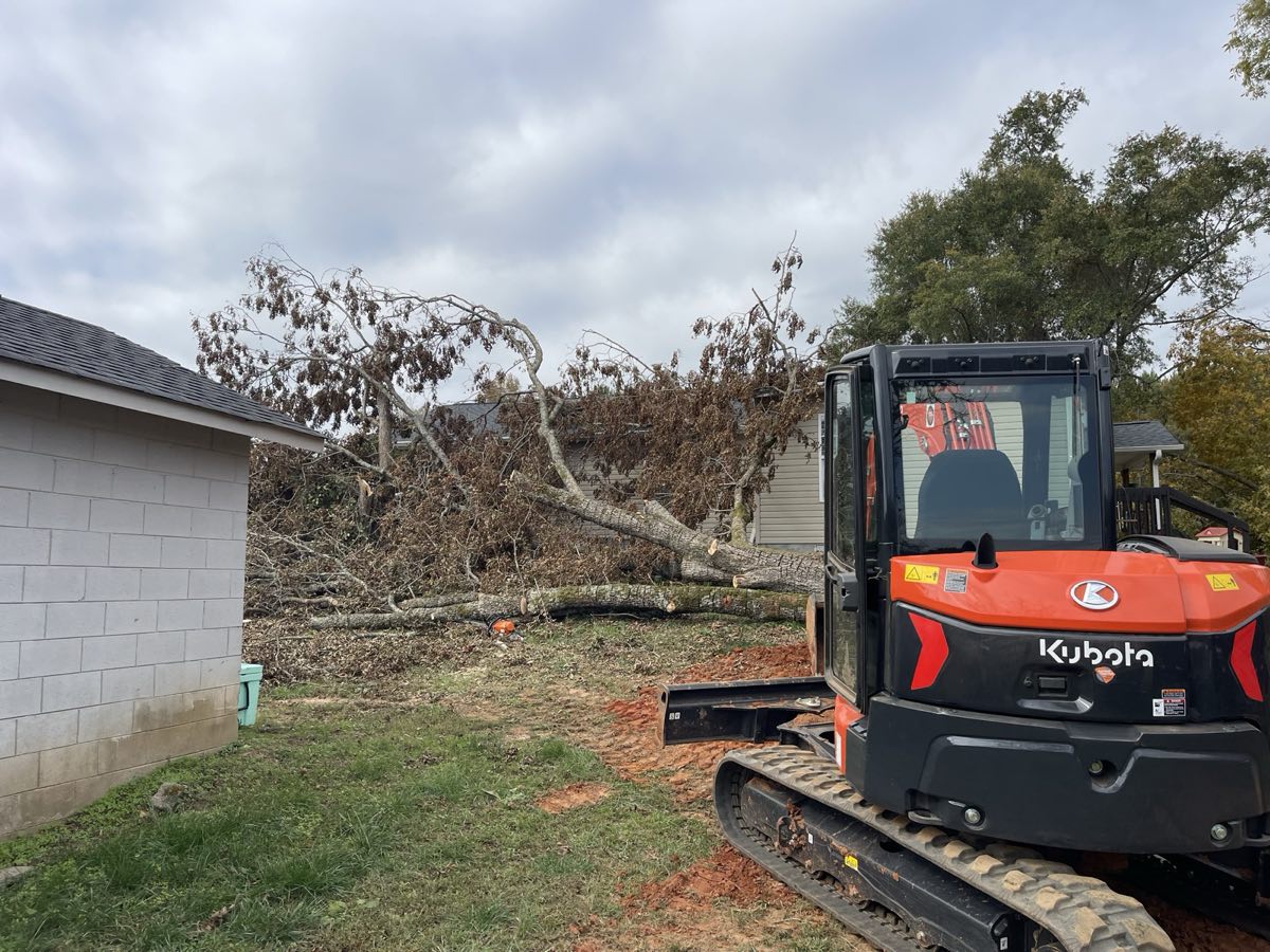 Kubota excavator removing storm-damaged trees in Pickens, SC