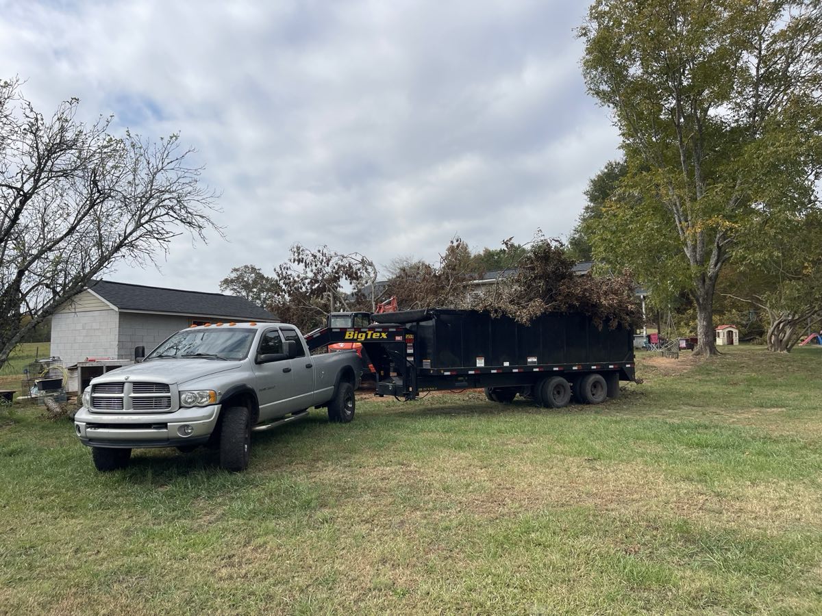 Truck and dump trailer hauling tree debris in Pickens, SC